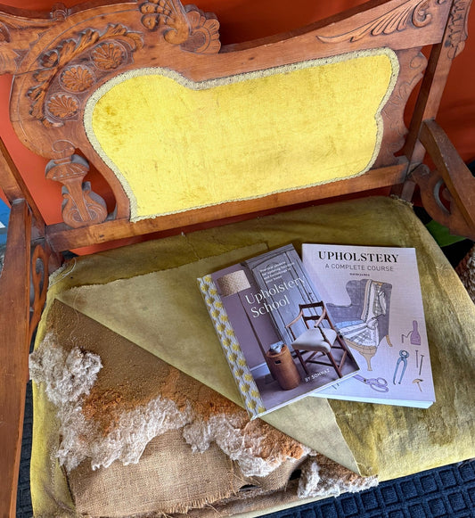 Antique upholstered chair showing traditional furniture restoration materials